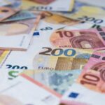 Closeup of a lot of euro banknotes scattered on the white table