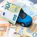 Toy car and euro on white