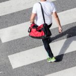 man wearing sportswear and carrying a gym bag